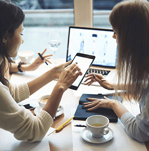 people-on-tablet-and-laptop consultants working on web development services for every device